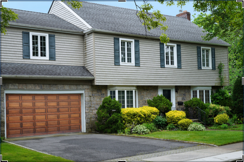 Gray two-story surburban home with attached two-story garage.